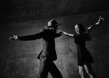Man and woman dancing urban dancing theme concrete building surroundings black and white image